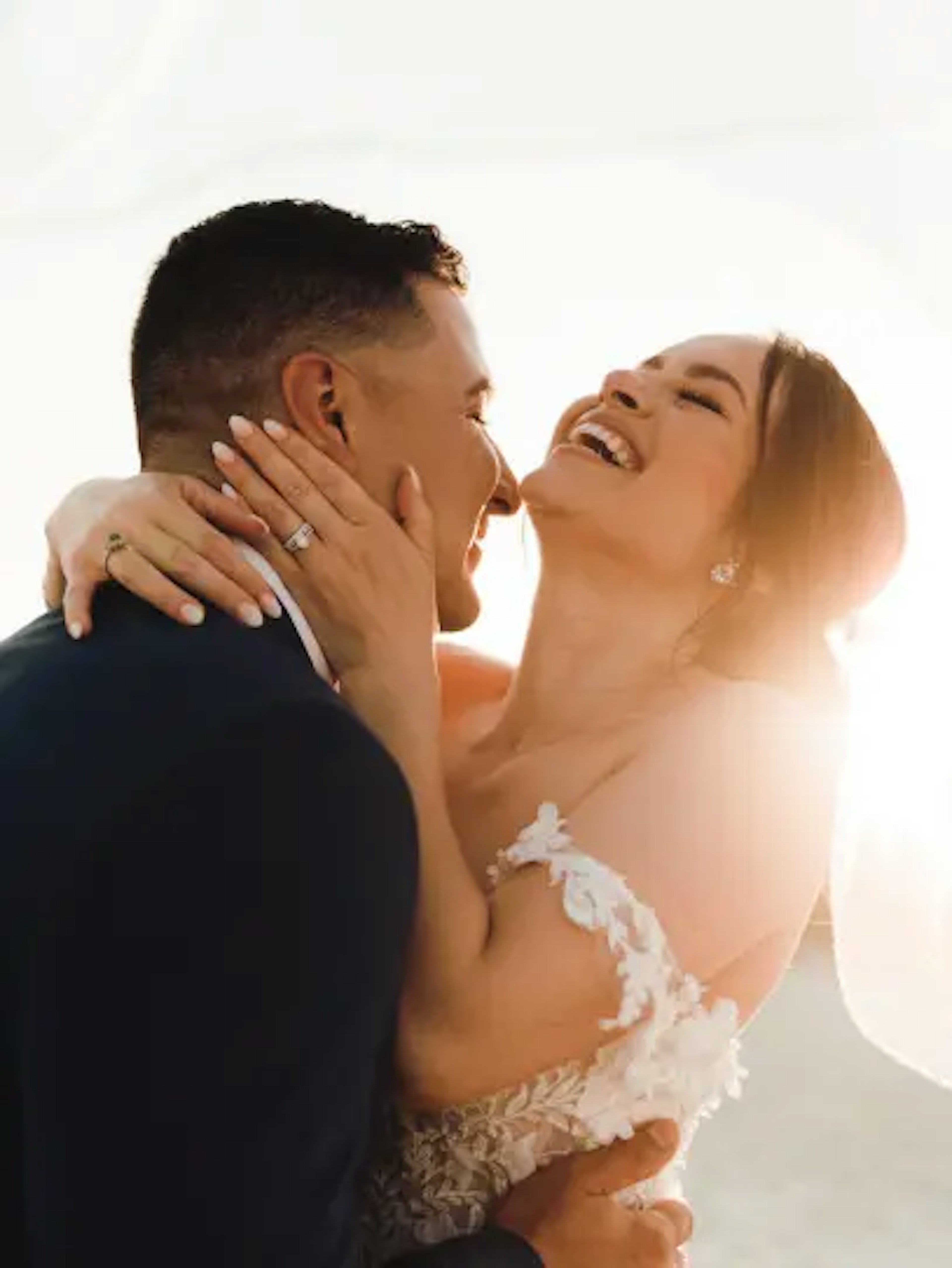 Newlywed couple sharing a joyful embrace on their wedding day in Riviera Maya